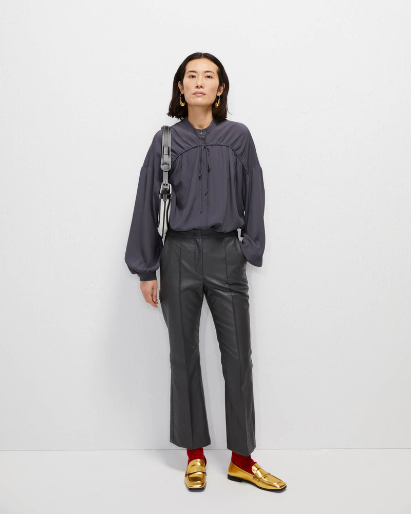 grey trumpet-shaped eco-leather trousers